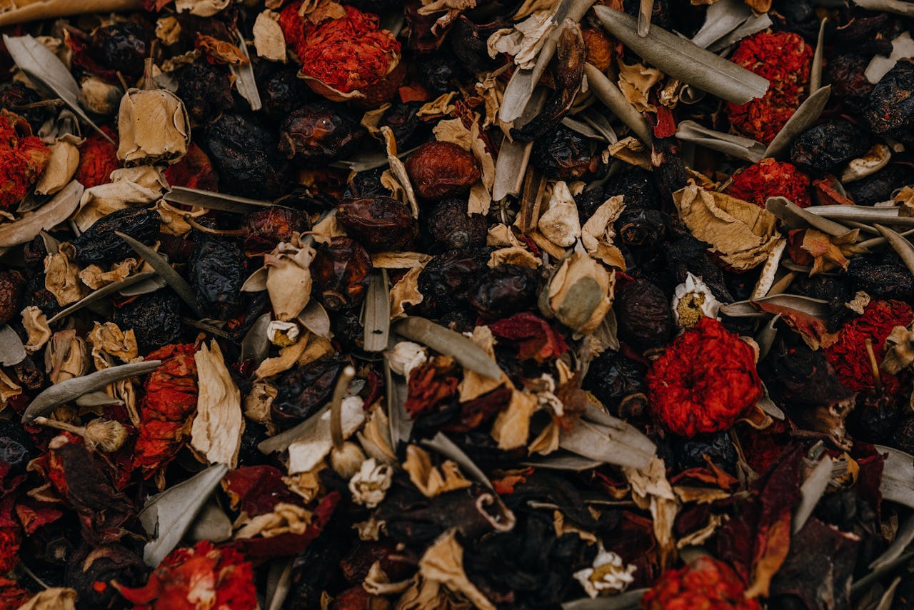 services-01 Rich close-up of a colorful herbal tea blend, combining dried fruits, leaves, and flowers for a perfect brew.